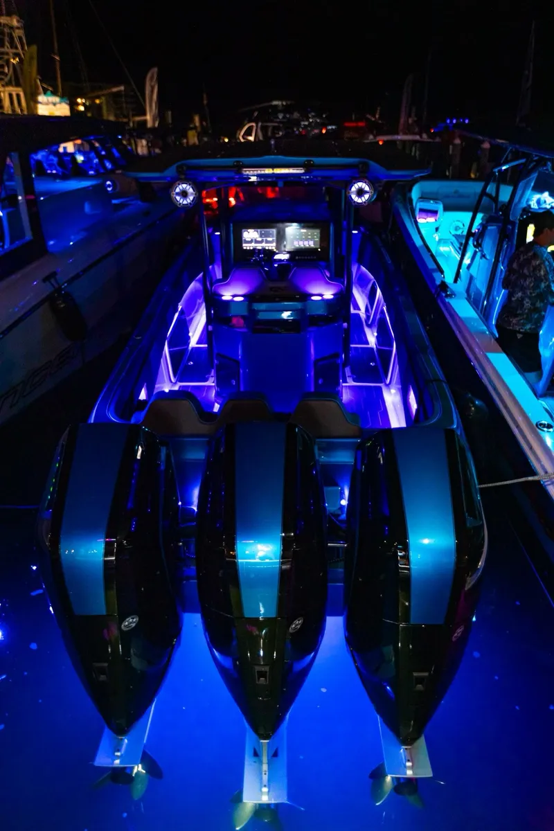 Slide: The Image of 2024 Glasstream GSX 36 boat with vibrant blue LED lighting at night. - 7