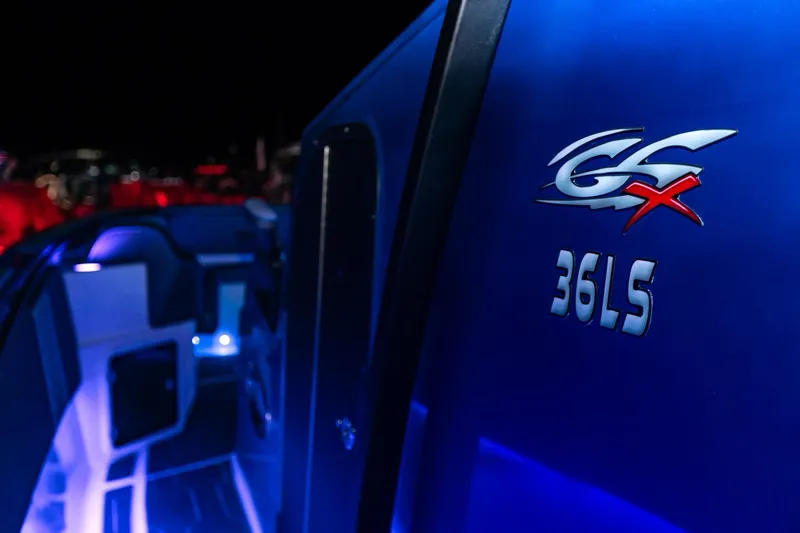 Slide: The Image of 2024 Glasstream GSX 36 boat with illuminated interior and logo at night. - 9