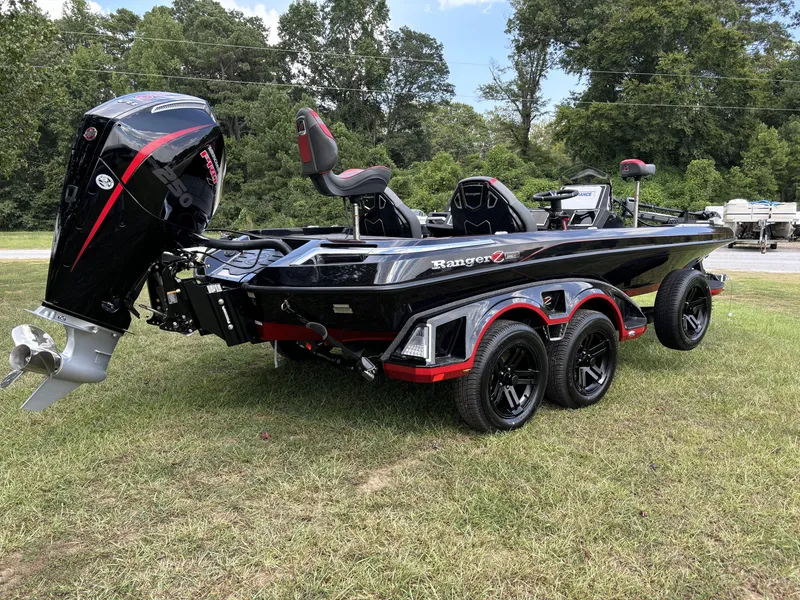 Slide: The Image of 2025 Ranger Z521R Ranger Cup Equipped boat on grass, showcasing sleek design and powerful engine. - 3
