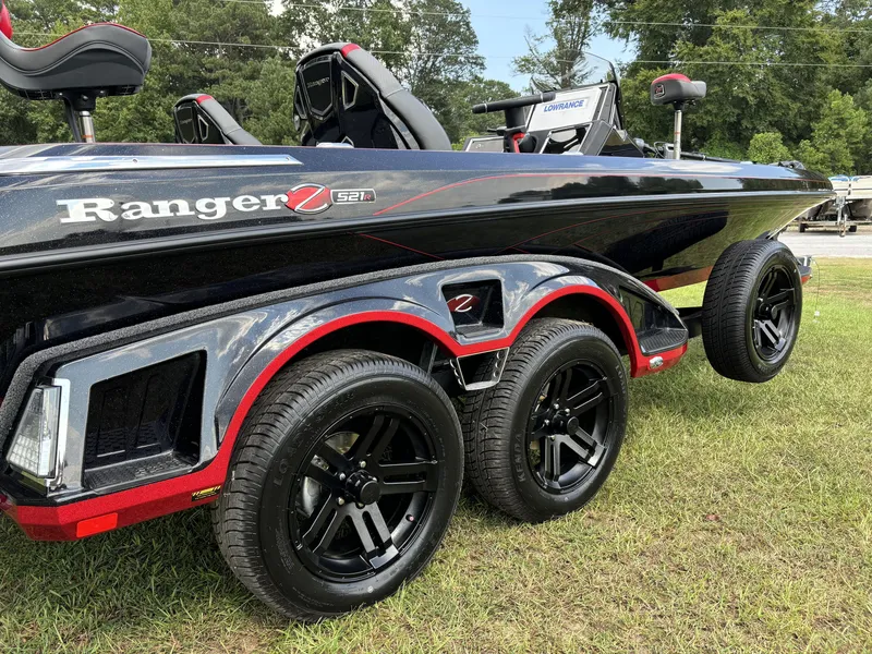Slide: The Image of 2025 Ranger Z521R Ranger Cup Equipped boat on grass, showcasing sleek design and wheels. - 4