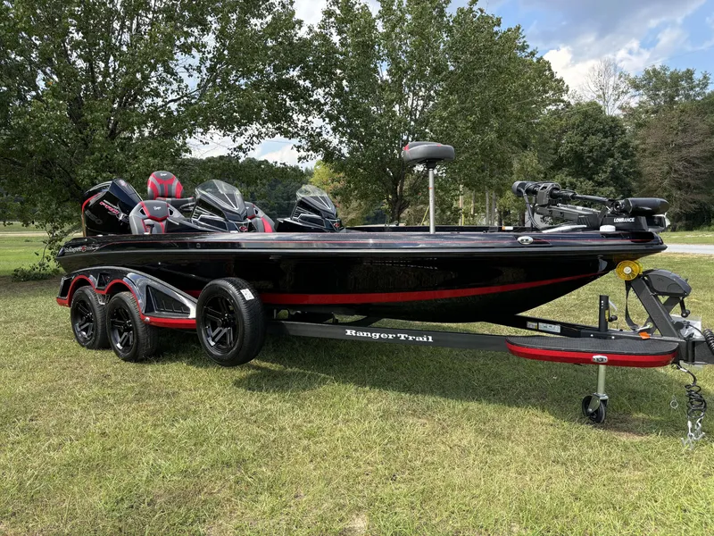 Slide: The Image of 2025 Ranger Z521R Ranger Cup Equipped boat on trailer, parked on grass. - 9