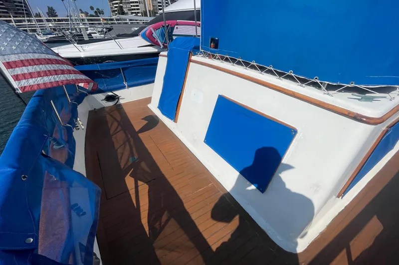 Slide: The Image of 1979 Golden Star Aft Cabin boat deck with American flag and blue accents. - 10