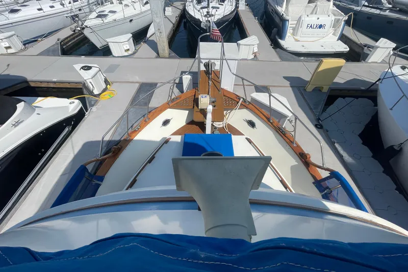 Slide: The Image of 1979 Golden Star Aft Cabin boat docked at a marina, surrounded by other vessels. - 12