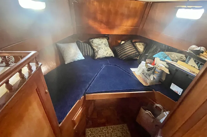 Slide: The Image of Cozy 1979 Golden Star Aft Cabin interior with blue bedding and wooden accents. - 21
