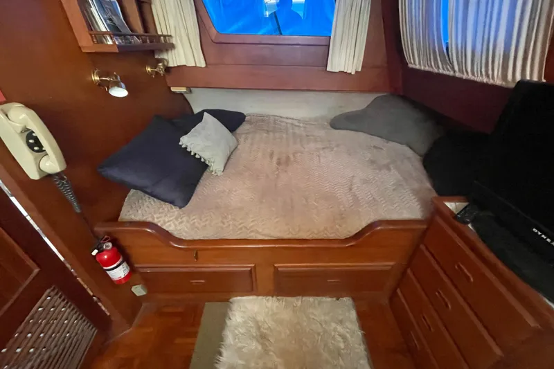 Slide: The Image of Cozy 1979 Golden Star Aft Cabin bedroom with wood accents and nautical decor. - 24