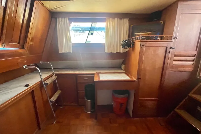 Slide: The Image of 1979 Golden Star Aft Cabin interior with wooden cabinetry and desk area. - 26