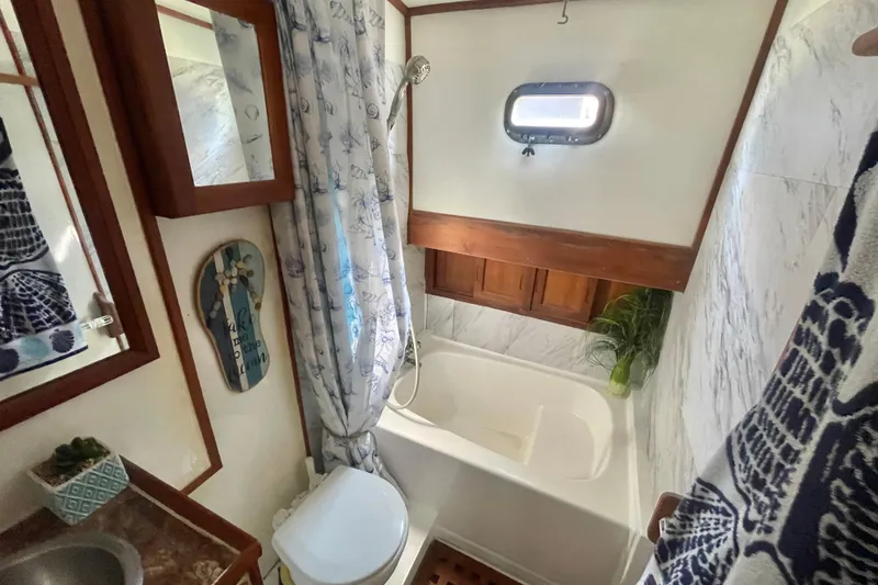 Slide: The Image of 1979 Golden Star Aft Cabin bathroom with nautical decor and compact design. - 27