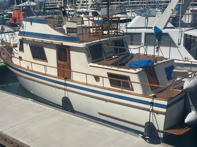 Slide: The Image of 1979 Golden Star Aft Cabin boat docked at marina, featuring classic design and wooden accents. - 3