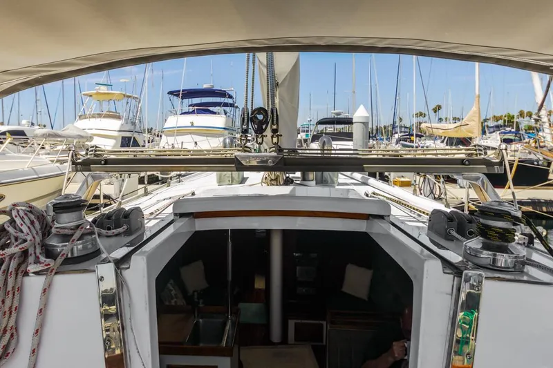 Slide: The Image of 1972 Columbia 43 Custom sailboat docked in a marina, surrounded by other boats. - 12