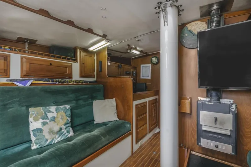 Slide: The Image of Interior of a 1972 Columbia 43 Custom sailboat with cozy seating and wood-burning stove. - 14