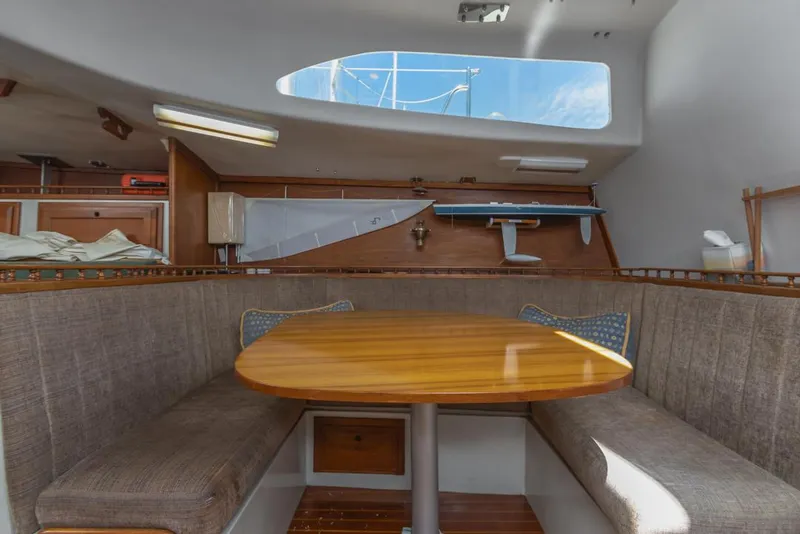 Slide: The Image of 1972 Columbia 43 Custom yacht interior with wooden table and cushioned seating. - 16