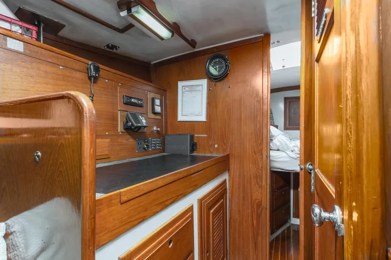 Slide: The Image of Interior of 1972 Columbia 43 Custom sailboat with wooden cabinetry and navigation equipment. - 18