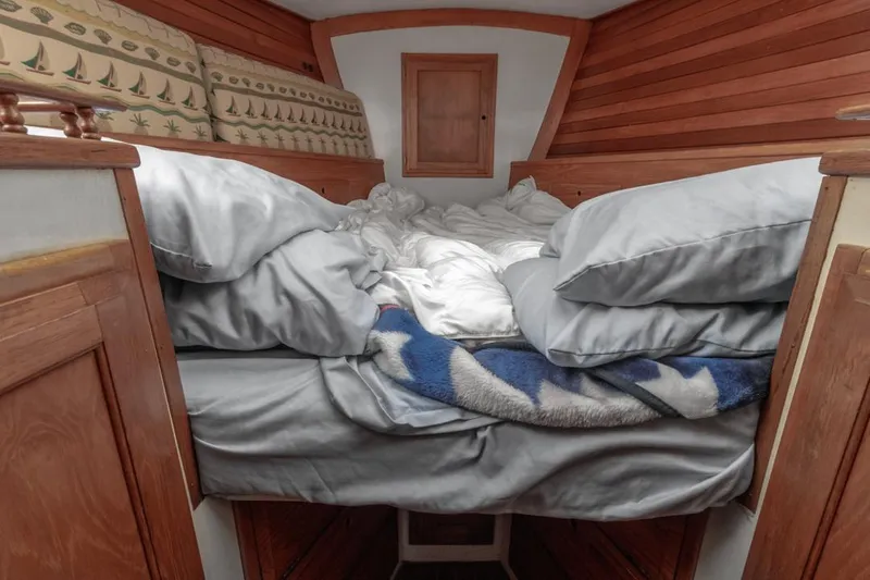 Slide: The Image of Cozy cabin bed in 1972 Columbia 43 Custom sailboat with wooden interior. - 19