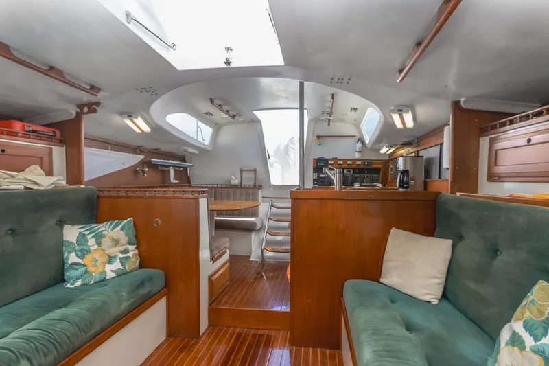 Slide: The Image of Interior of 1972 Columbia 43 Custom sailboat with wooden finishes and green seating. - 22