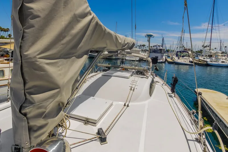 Slide: The Image of 1972 Columbia 43 Custom sailboat docked in a marina, surrounded by other boats. - 4
