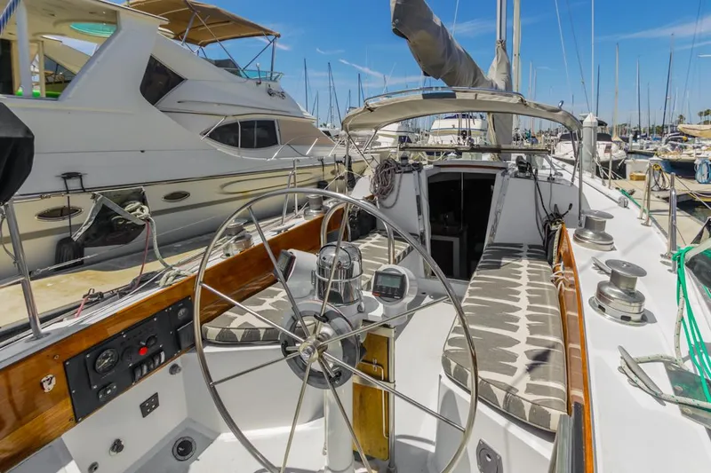 Slide: The Image of 1972 Columbia 43 Custom sailboat with spacious cockpit and steering wheel, docked at marina. - 8