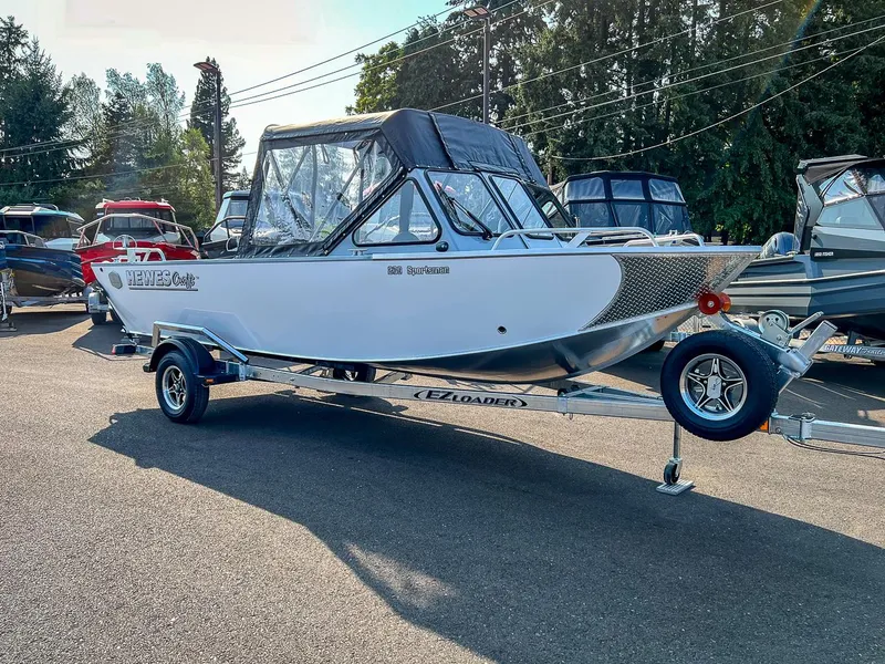 Slide: The Image of 2024 Hewescraft 200 Sportsman boat on trailer in outdoor showroom. - 1