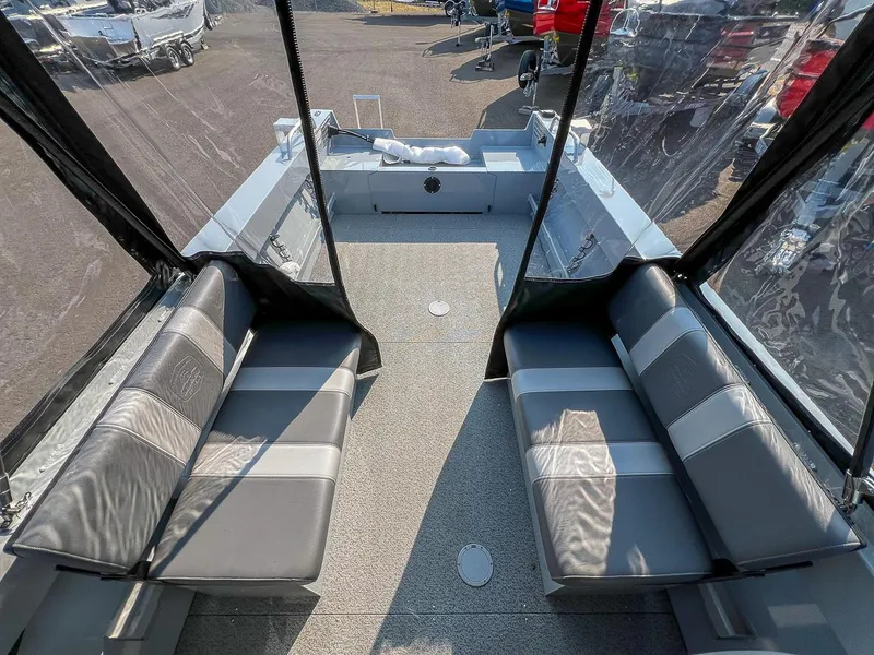 Slide: The Image of 2024 Hewescraft 200 Sportsman interior with gray seating and clear canopy. - 11