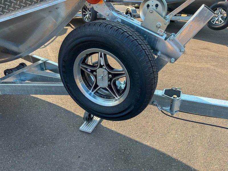 Slide: The Image of 2024 Hewescraft 200 Sportsman trailer wheel on asphalt. - 14