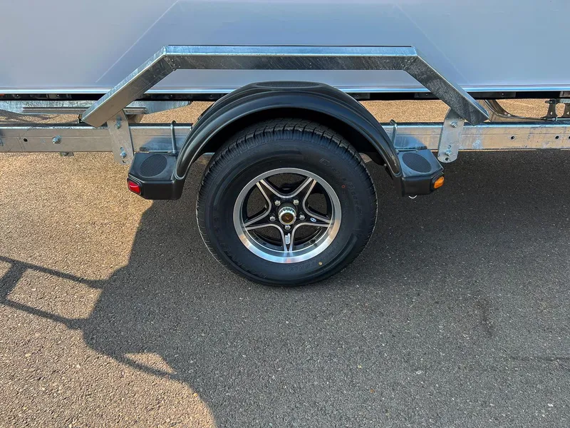 Slide: The Image of 2024 Hewescraft 200 Sportsman trailer wheel on asphalt surface. - 15