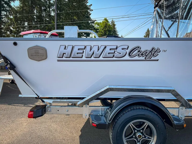 Slide: The Image of 2024 Hewescraft 200 Sportsman boat on trailer, side view with logo visible. - 16