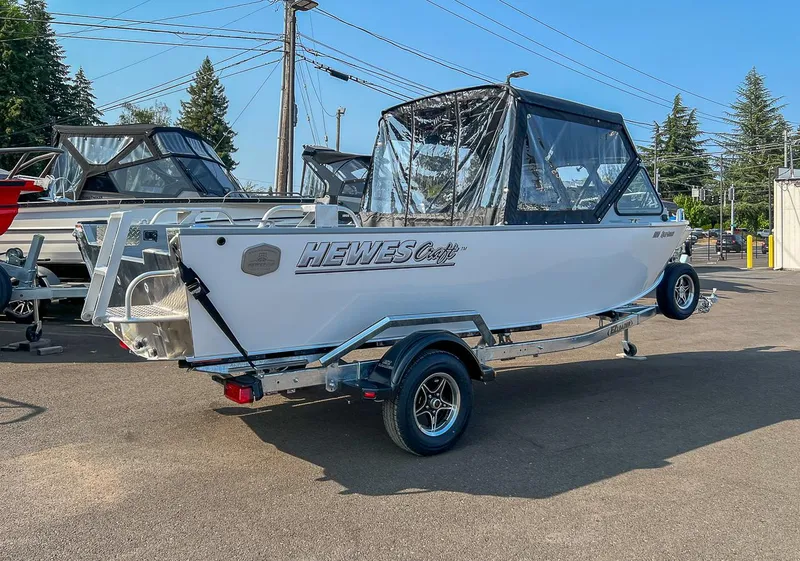 Slide: The Image of 2024 Hewescraft 200 Sportsman boat on trailer in outdoor setting. - 3