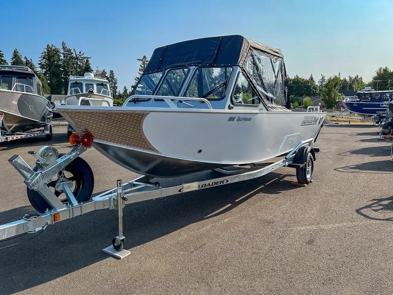 Slide: The Image of 2024 Hewescraft 200 Sportsman boat on trailer in outdoor setting. - 6