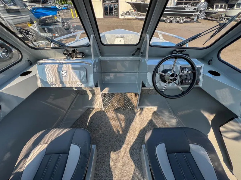 Slide: The Image of Interior of 2024 Hewescraft 200 Sportsman boat with steering wheel and seating. - 8