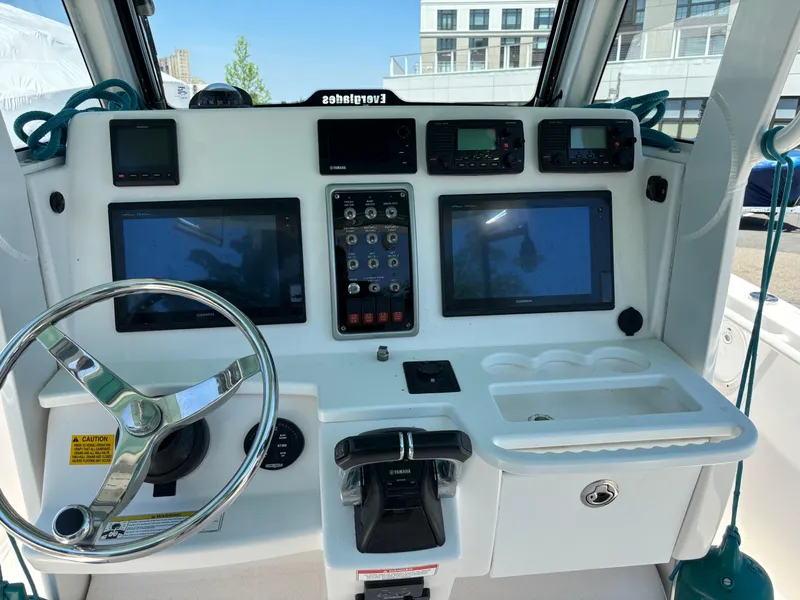 Slide: The Image of 2014 Everglades 295 boat dashboard with steering wheel and electronic displays. - 15
