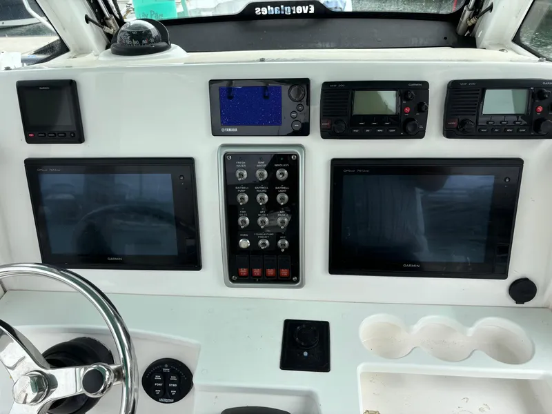 Slide: The Image of Dashboard of 2014 Everglades 295 boat with navigation and control systems. - 16