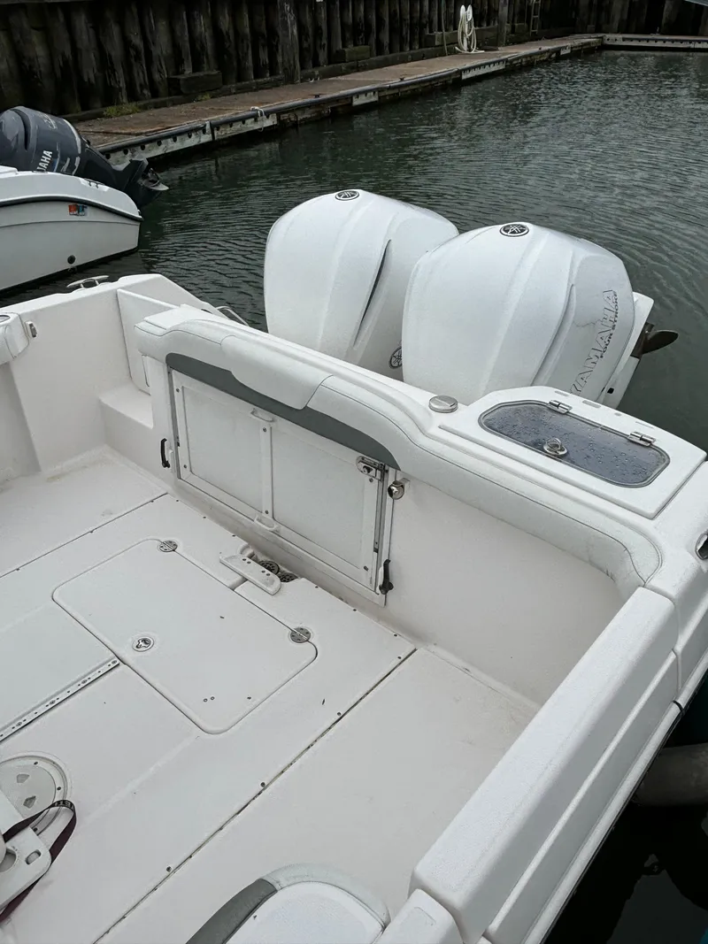 Slide: The Image of 2014 Everglades 295 boat with dual outboard engines docked in marina. - 17