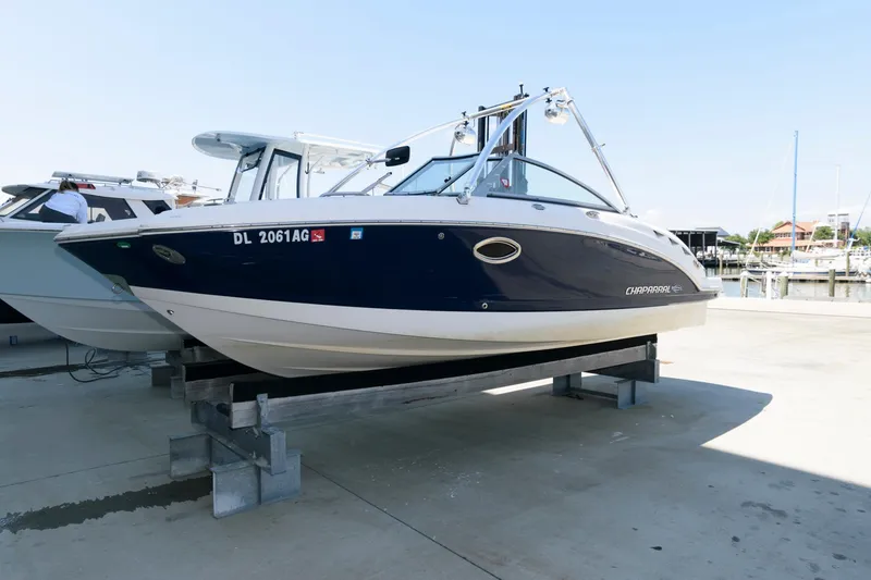 The Image of 2013 Chaparral 224 Sunesta boat on display at a marina, elevated on supports. - 0