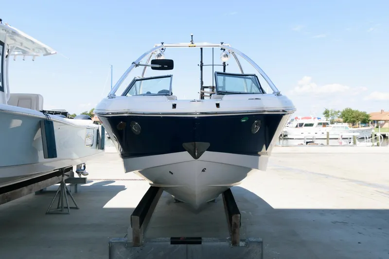 Slide: The Image of 2013 Chaparral 224 Sunesta boat on display at a marina. - 2