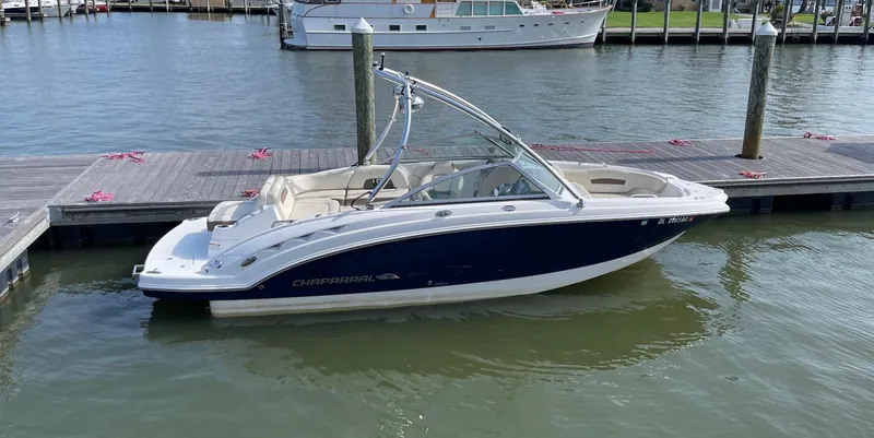 Slide: The Image of 2013 Chaparral 224 Sunesta boat docked on calm water. - 3