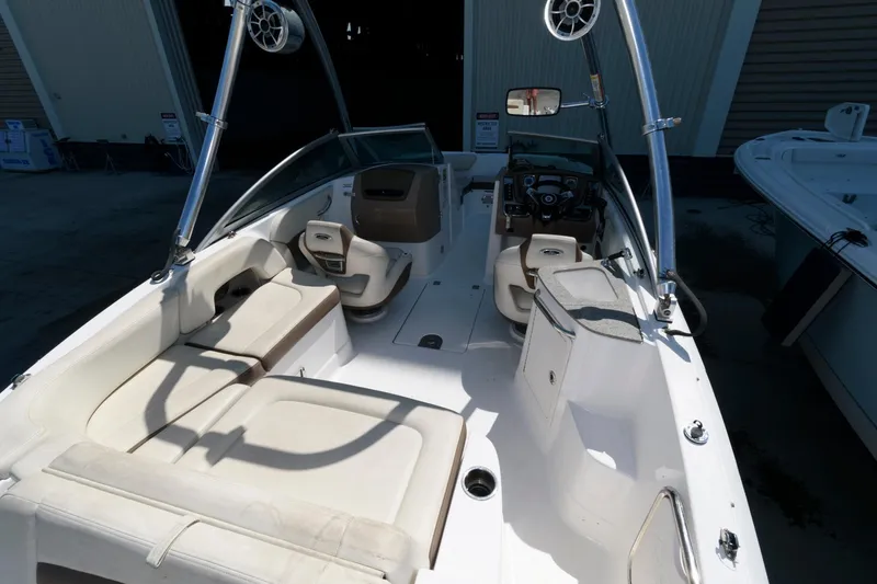 Slide: The Image of 2013 Chaparral 224 Sunesta boat interior with beige seating and modern dashboard. - 4