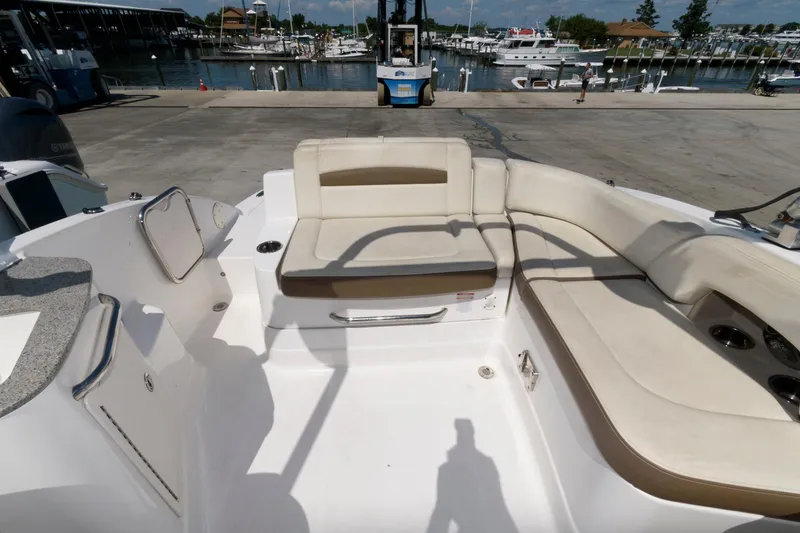 Slide: The Image of 2013 Chaparral 224 Sunesta boat interior with beige seating at marina. - 8