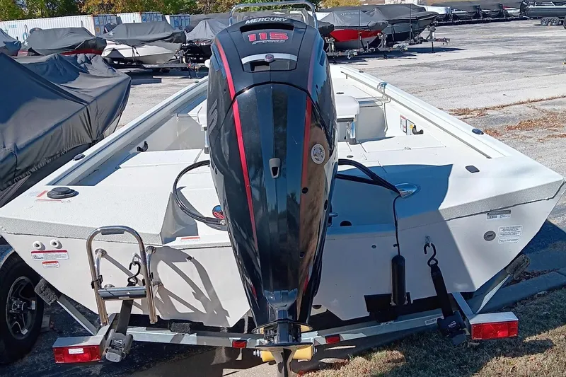 Slide: The Image of 2024 Ranger RB190 boat with Mercury outboard motor on trailer, parked outdoors. - 2