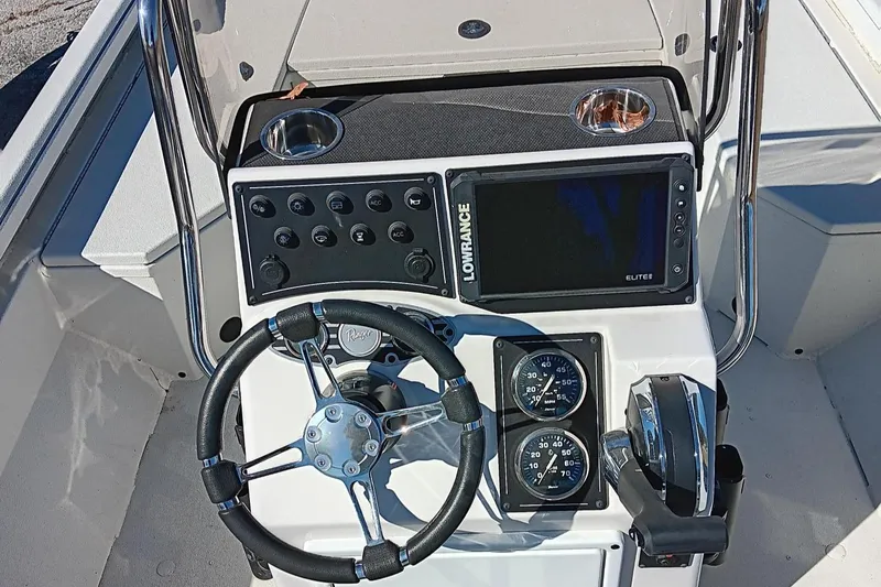 Slide: The Image of 2024 Ranger RB190 boat console with steering wheel, gauges, and Lowrance display. - 5