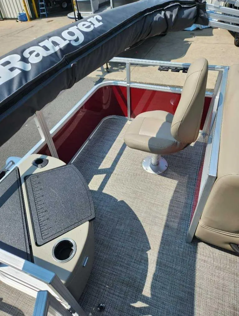 Slide: The Image of 2024 Ranger Reata 200F boat interior with beige seating and red accents. - 3