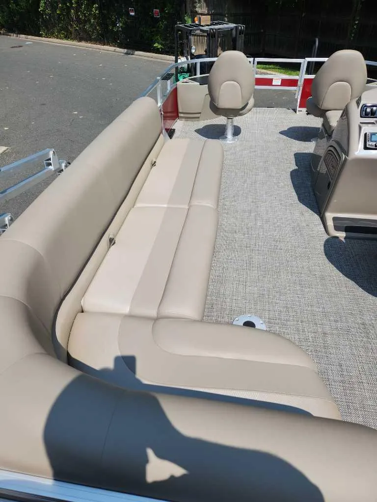 Slide: The Image of 2024 Ranger Reata 200F boat interior with beige seating and carpeted floor. - 4