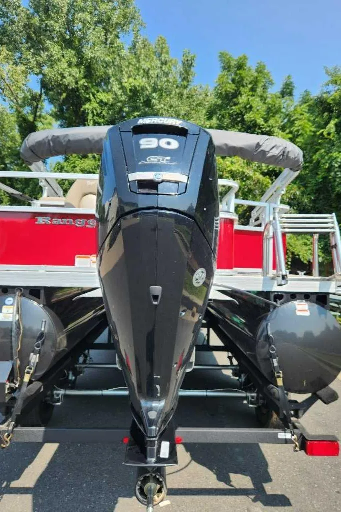 Slide: The Image of 2024 Ranger Reata 200F boat with powerful outboard motor, parked outdoors. - 6