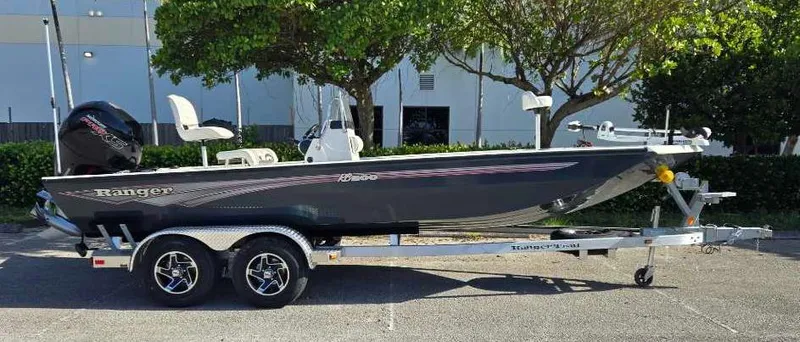 Slide: The Image of 2024 Ranger RB200 boat on trailer, parked outdoors, side view. - 1
