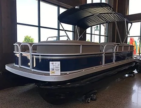 The Image of 2024 Ranger Reata 200C pontoon boat with canopy in showroom. - 0