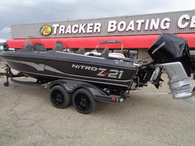 Slide: The Image of 2024 Nitro ZV21 Pro boat on trailer outside boating center. - 2