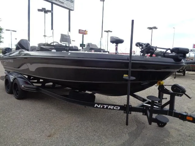 Slide: The Image of 2024 Nitro ZV21 Pro boat on trailer in outdoor setting. - 4