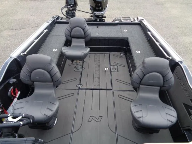 Slide: The Image of 2024 Nitro ZV21 Pro boat interior with four black seats and spacious deck layout. - 6