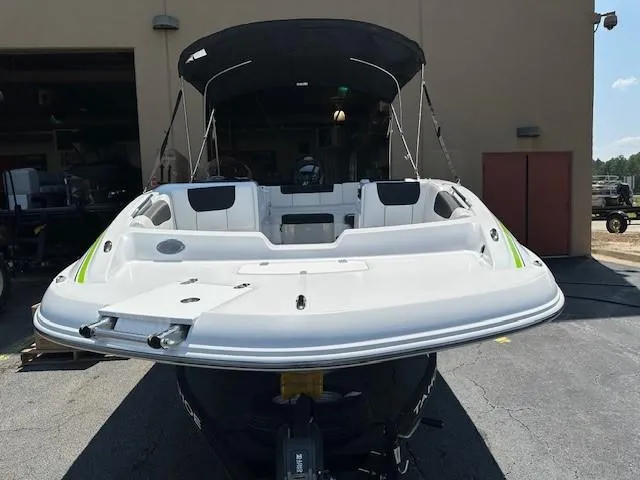 Slide: The Image of 2024 Tahoe 1950 boat, white exterior, parked outdoors, rear view. - 3