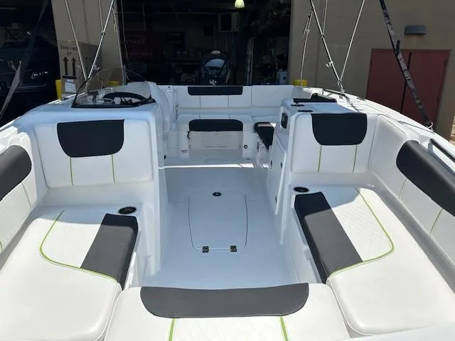 Slide: The Image of 2024 Tahoe 1950 boat interior with white and black seating, spacious layout. - 4