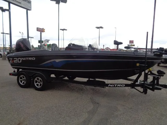 Slide: The Image of 2024 Nitro ZV20 boat on trailer outside Tracker Boats store in snowy setting. - 3