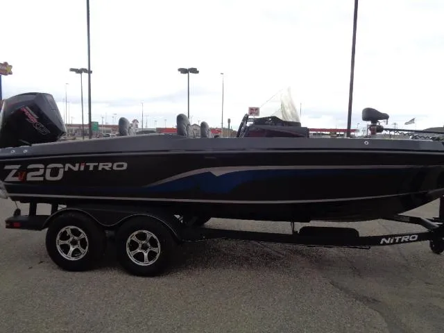 Slide: The Image of 2024 Nitro ZV20 boat on trailer outside Boating Center in snowy setting. - 4